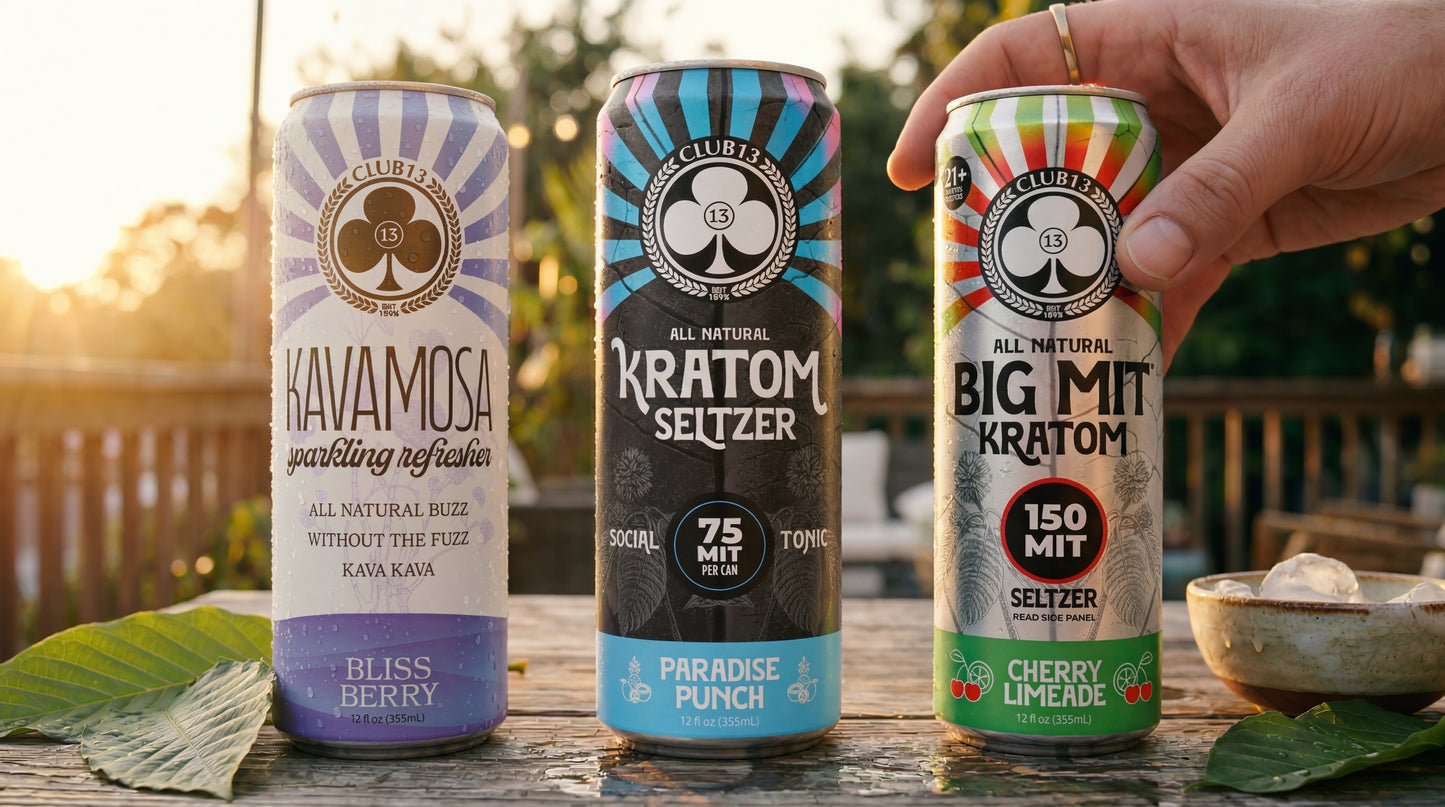 Three Club13 kratom drinks (Kavamosa Bliss Berry, Kratom Seltzer Paradise Punch 75 MIT, Big MIT 150 MIT Cherry Limeade) on a wooden deck at sunset, with kratom leaves nearby